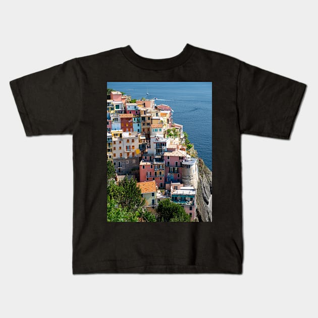 View on the cliff town of Manarola, one of the colorful Cinque Terre on the Italian west coast Kids T-Shirt by Dolfilms